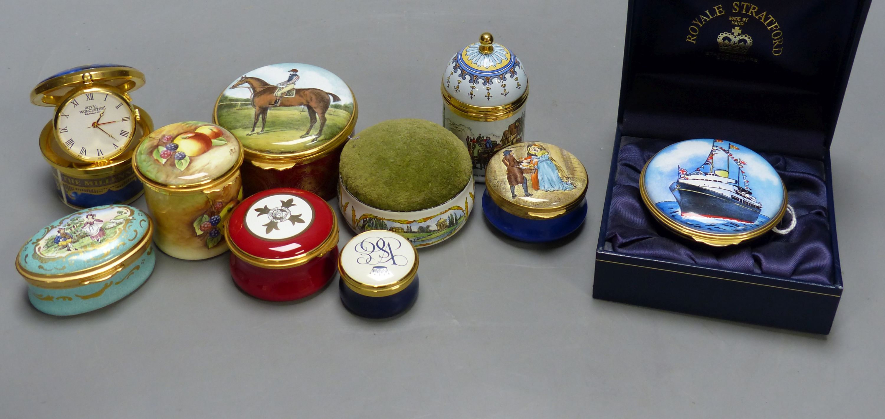 Nine enamelled boxes (one containing a watch, one with musical movement) and a similar pin cushion (10)